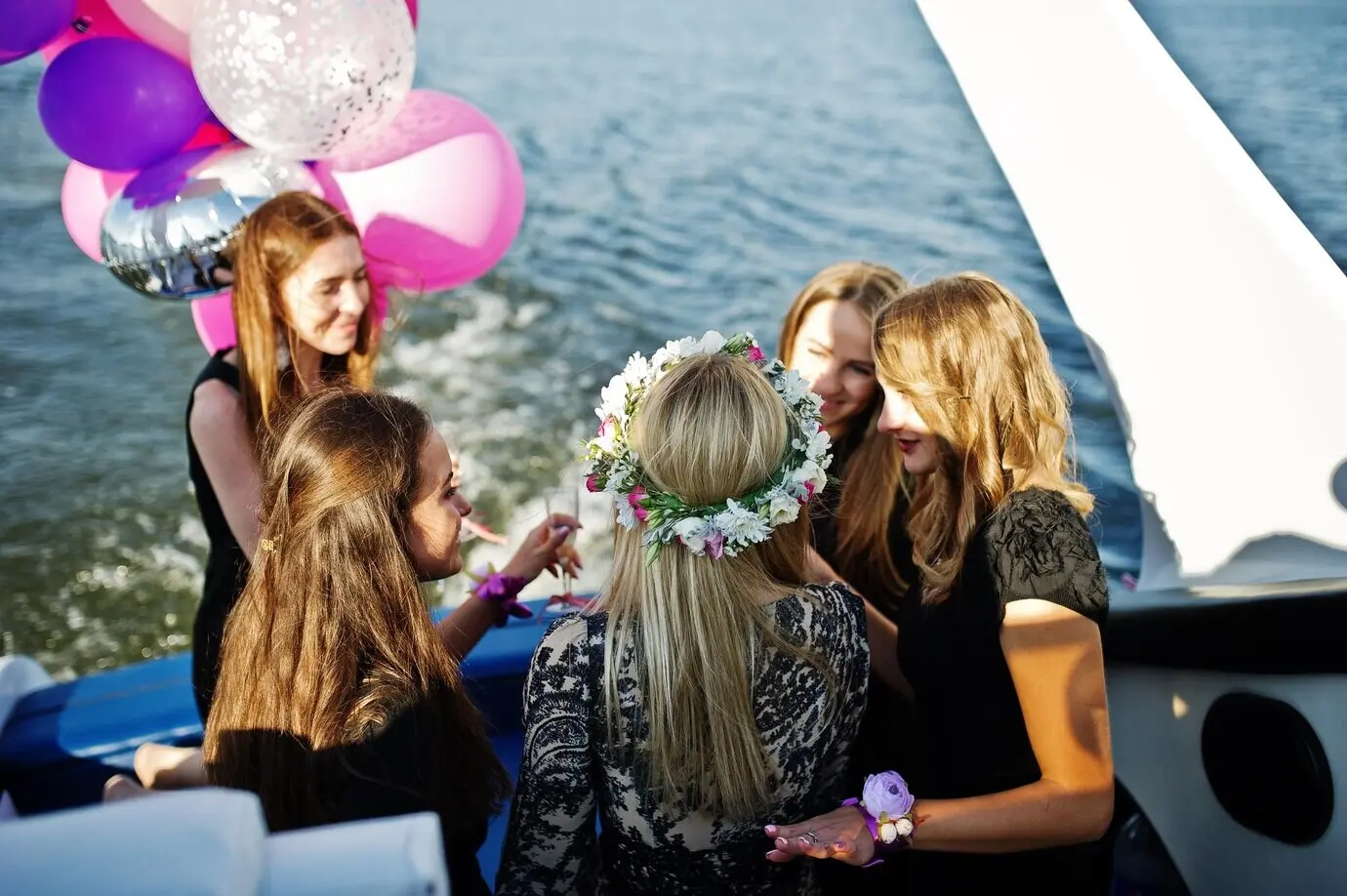 Girls having fun on a yacht at a hen party.